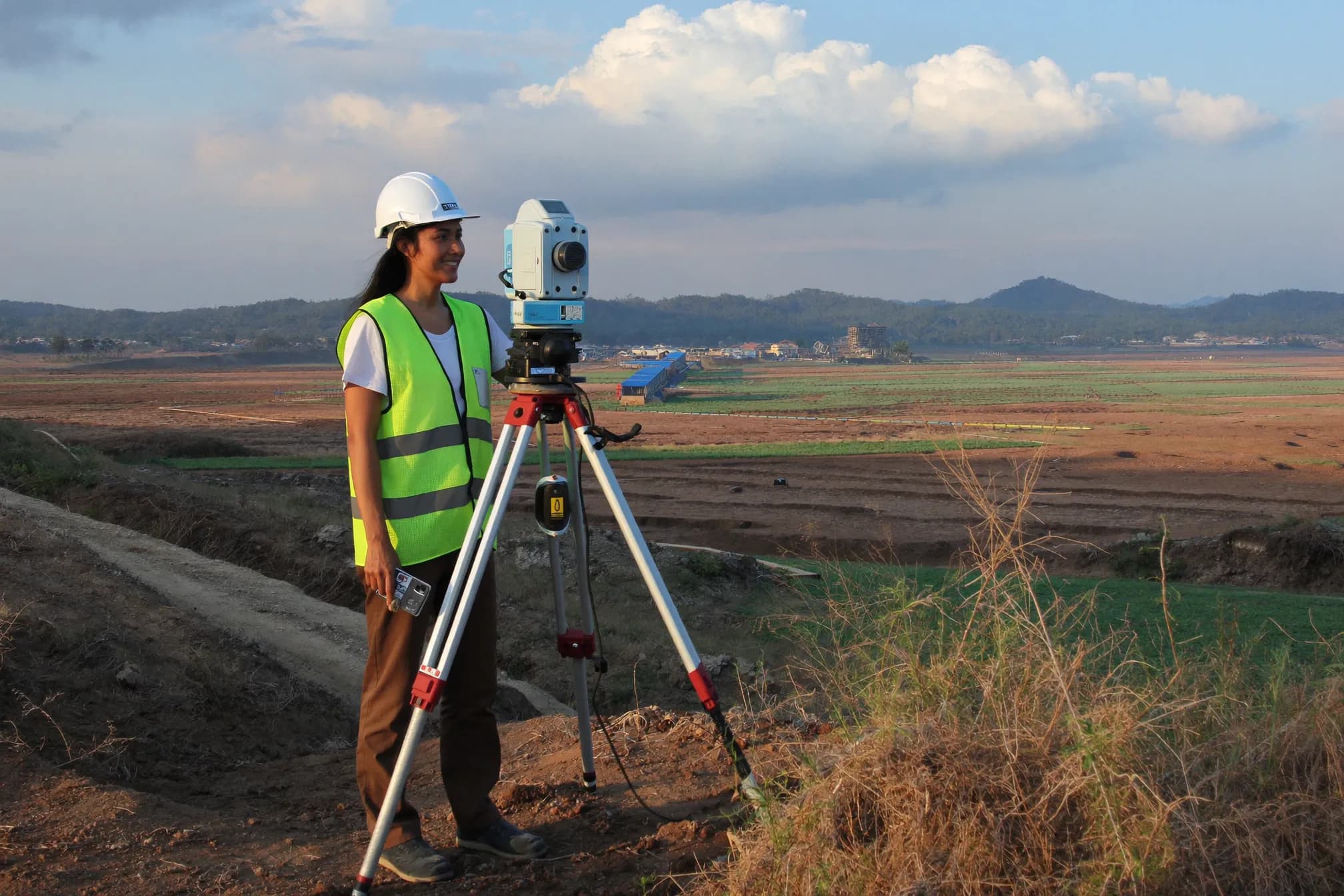 Geodetic survey engineer operating a total station on-site